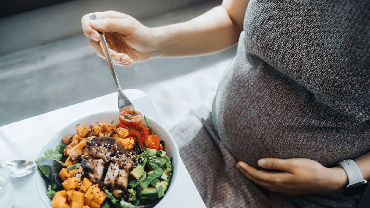 pregnant person eating a protein salad