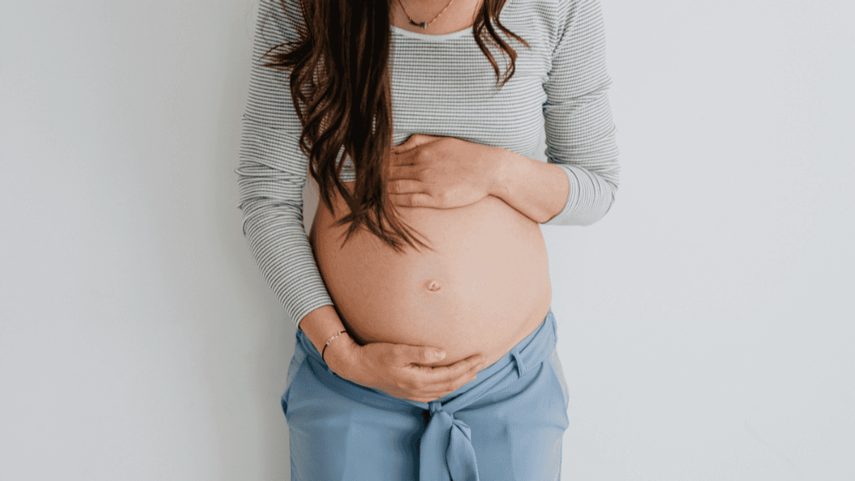 pregnant person holding their baby bump