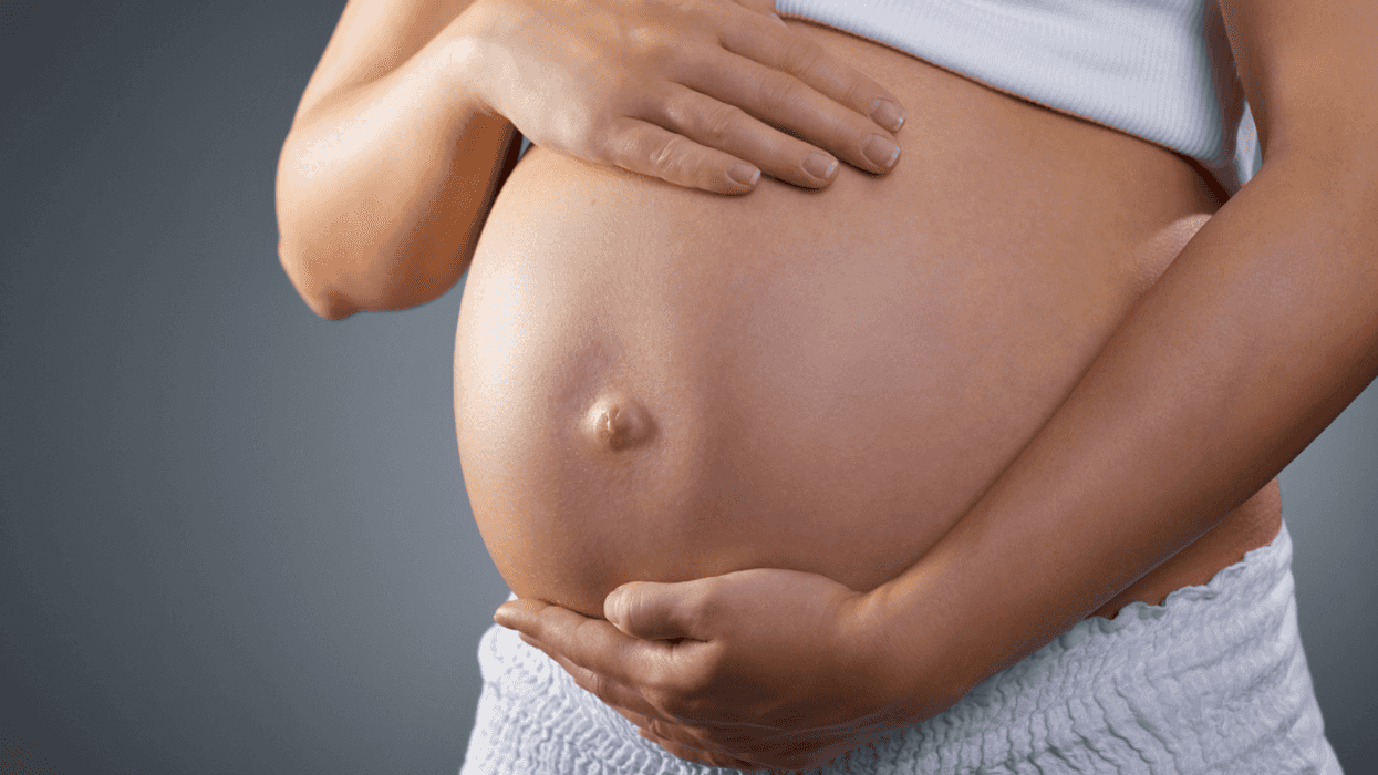 pregnant person holding their baby bump