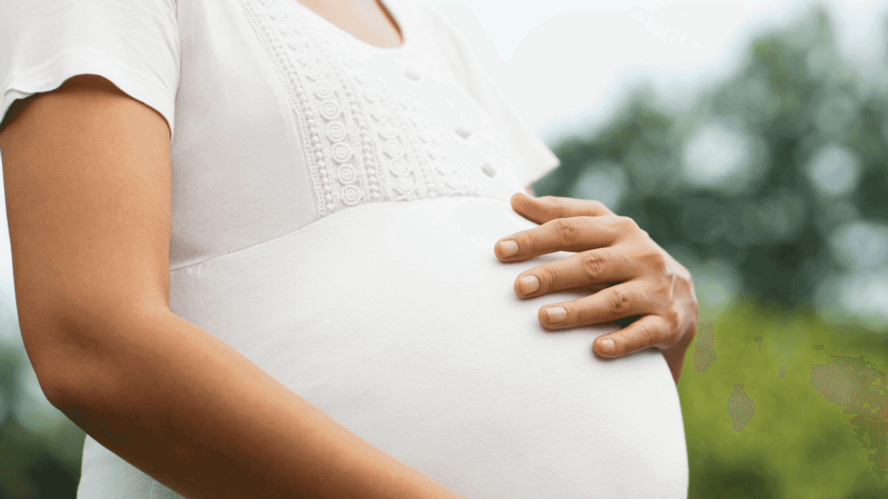 pregnant person with their hand on their belly