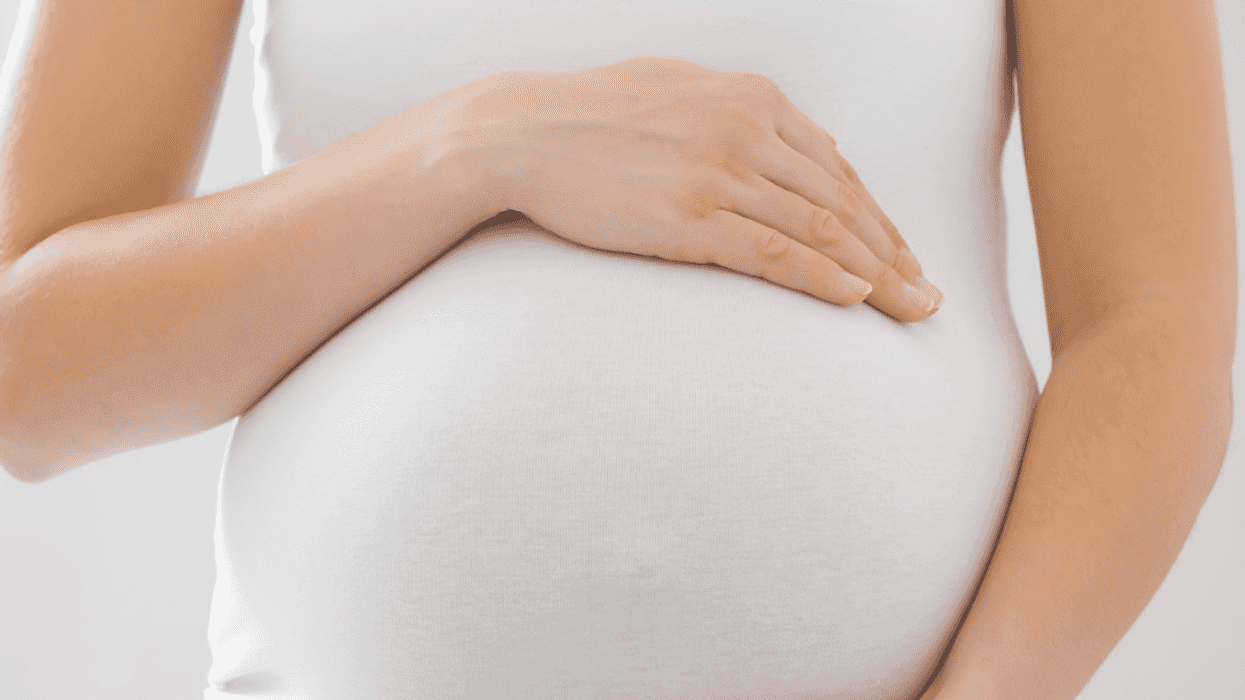 Pregnant woman holding her belly