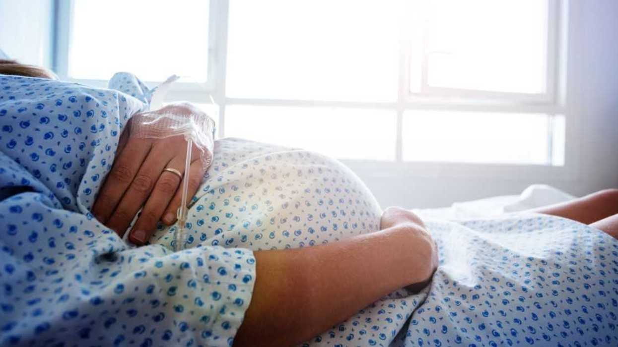 Pregnant woman in hospital bed