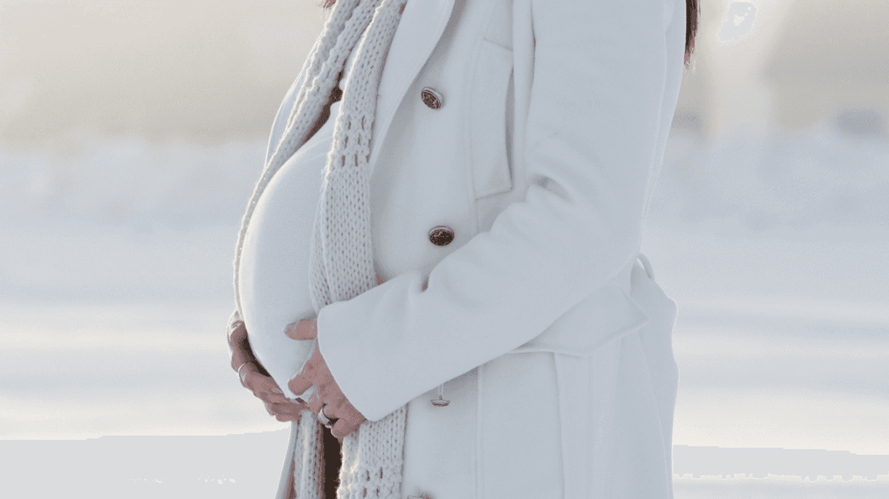 Pregnant woman outside in the snow