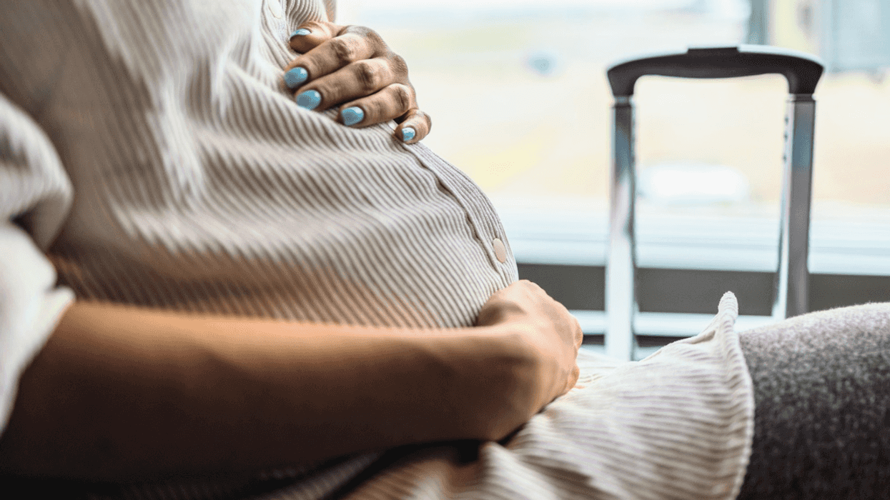 pregnant woman seated in an airport