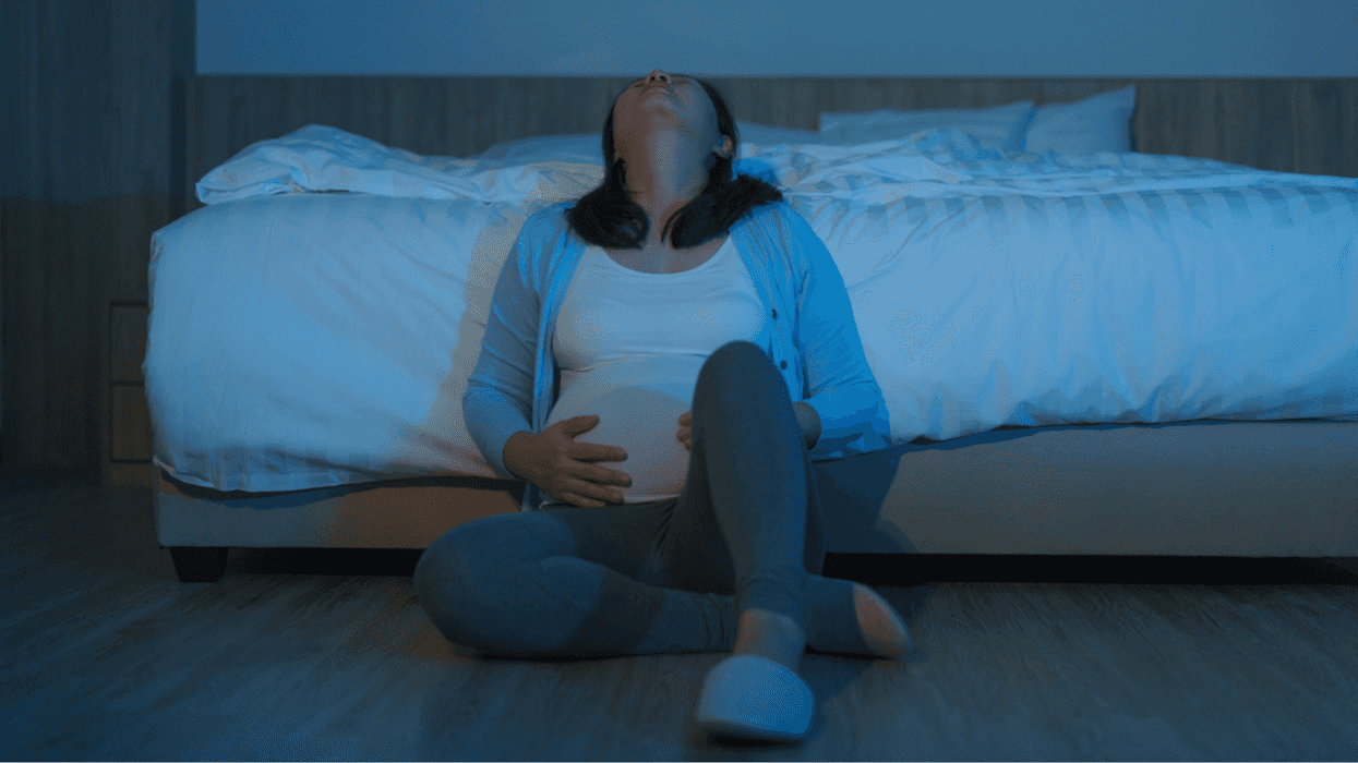 Pregnant woman sitting on the floor