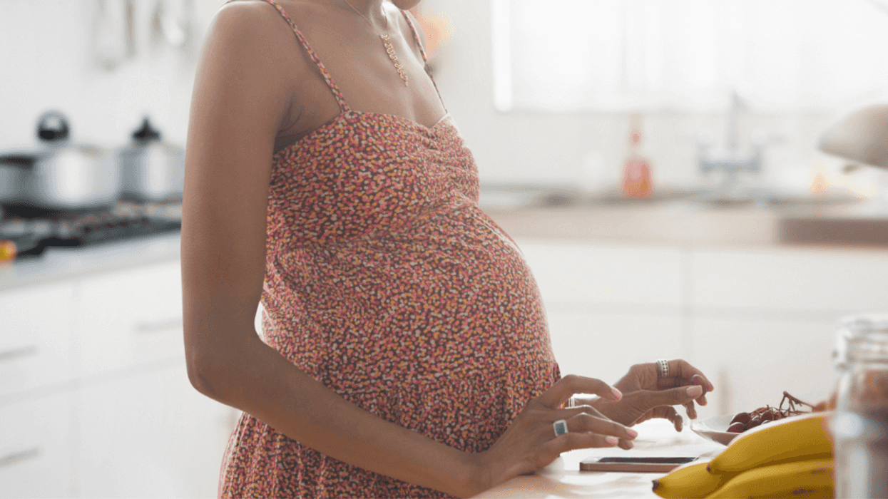 Pregnant woman standing in kitchen