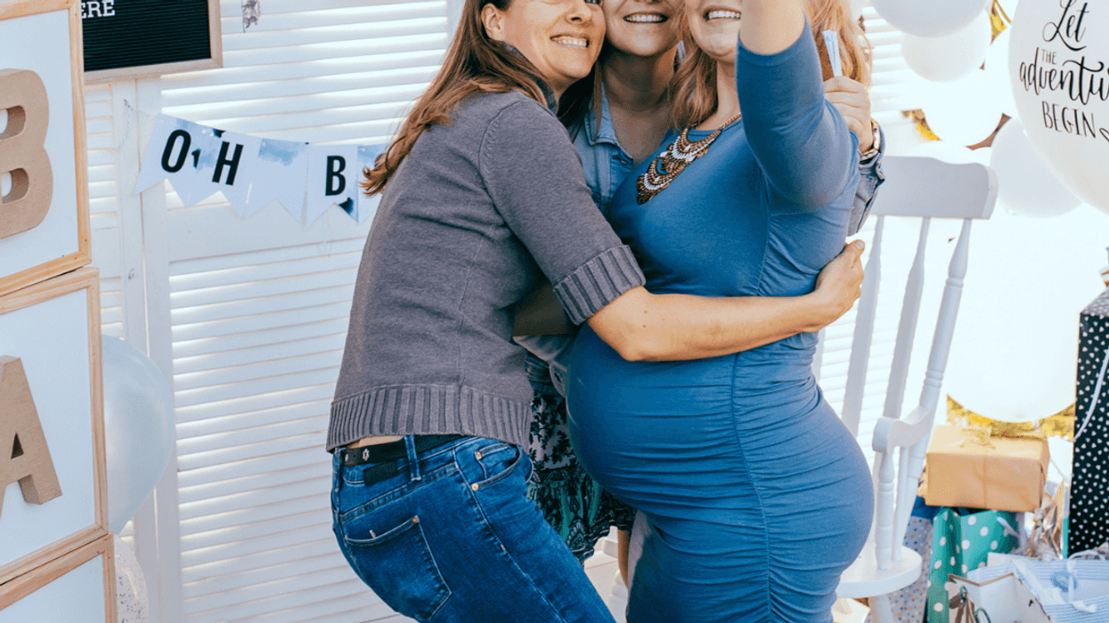Pregnant woman taking selfie at baby shower