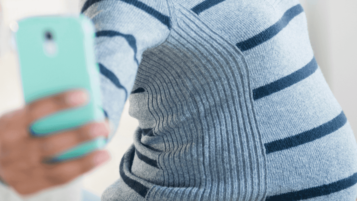 Pregnant woman taking selfie