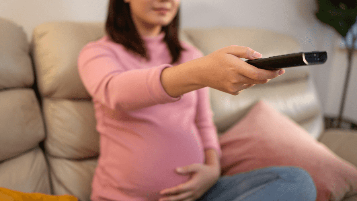 Pregnant woman watching television