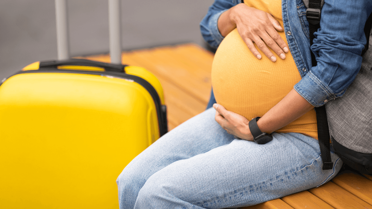 Pregnant woman with luggage