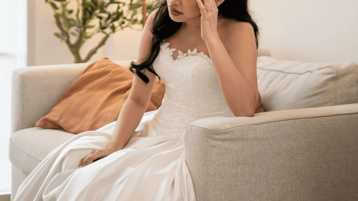 sad bride sitting alone on loveseat