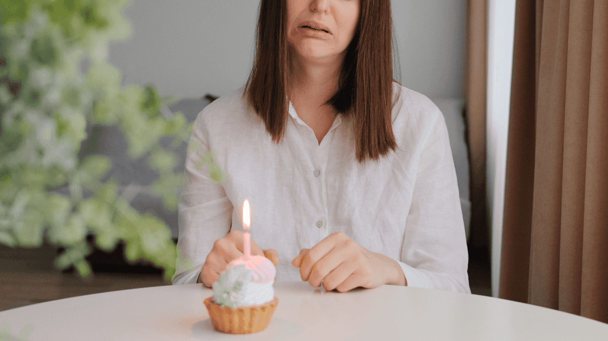 sad woman with birthday cupcake