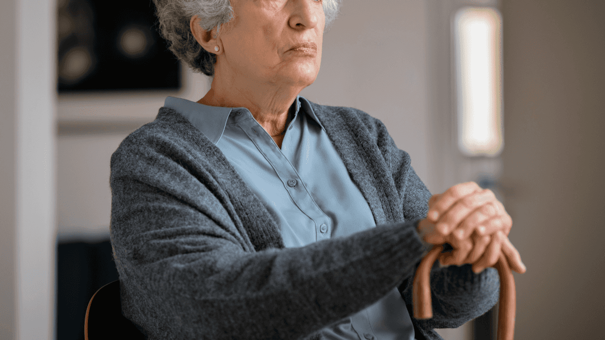 seated stern older woman with can