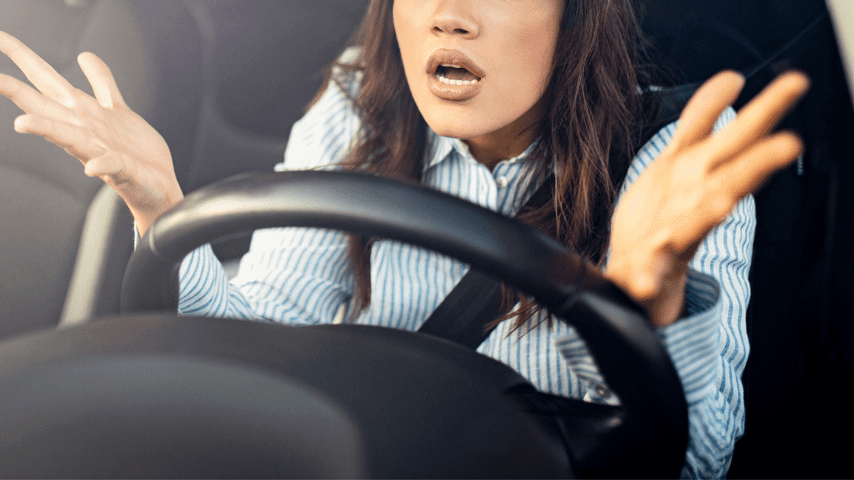 shocked looking woman in car