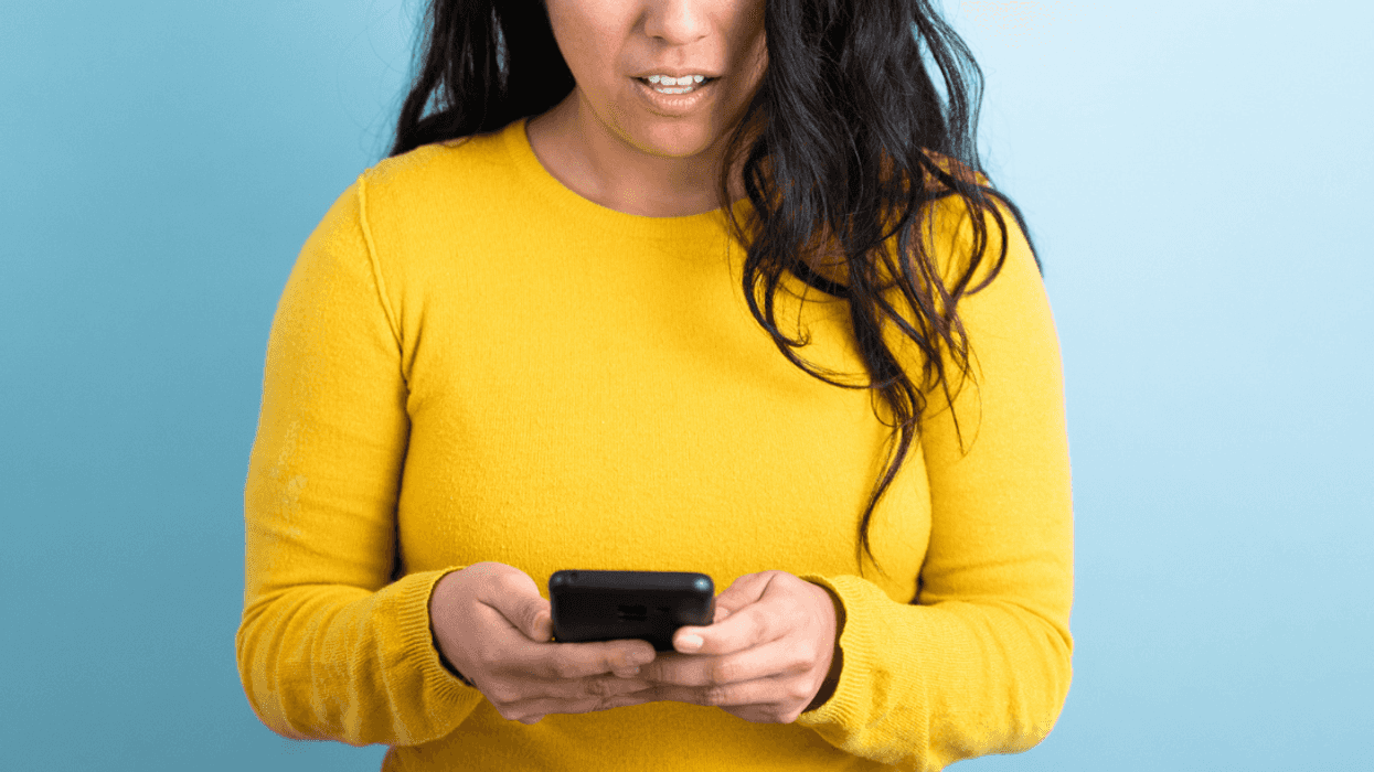 Shocked woman looking at her phone