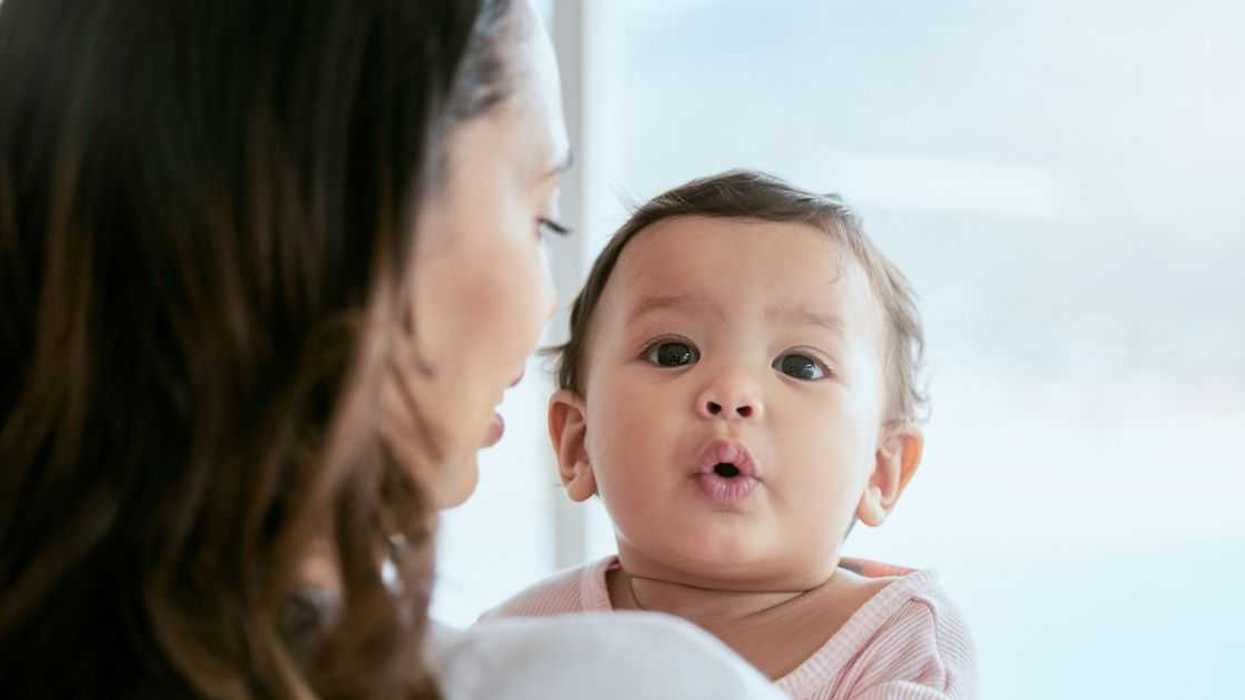 Shot of a mother holding her baby daughter at home