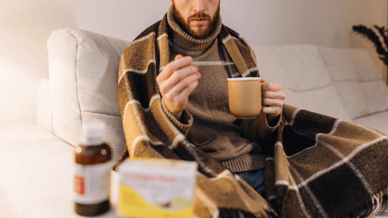 sick man taking his temperature