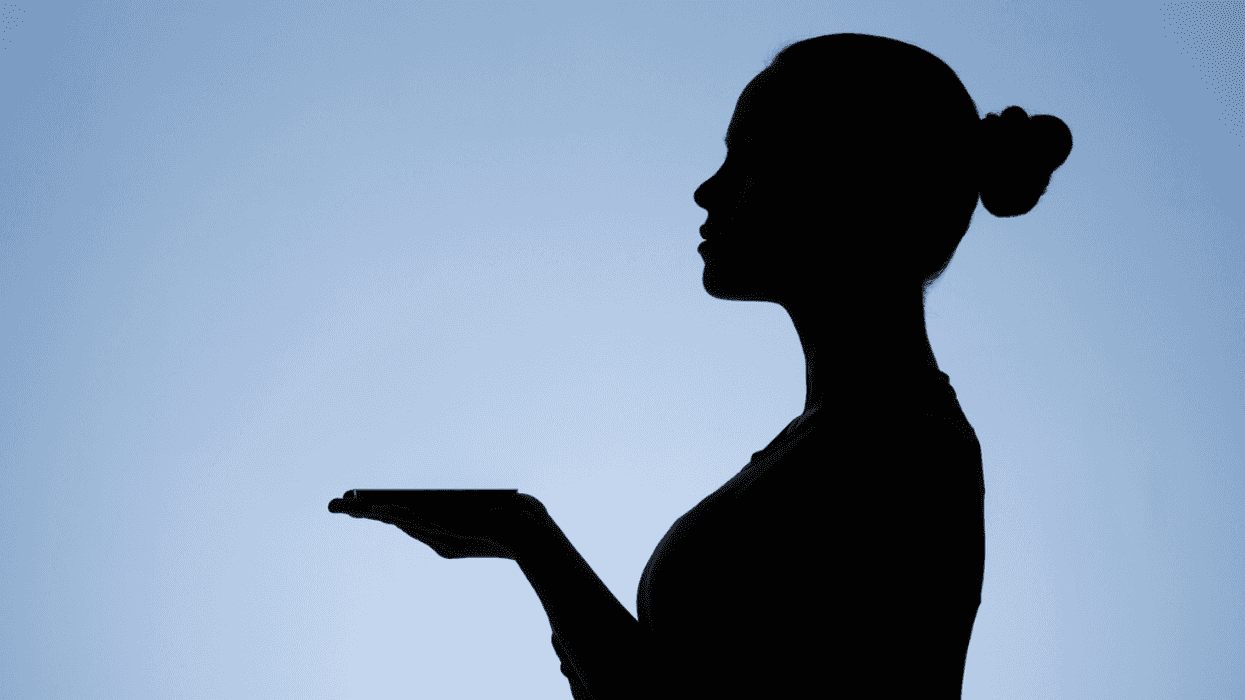 silhouette of server with payment tray on hand