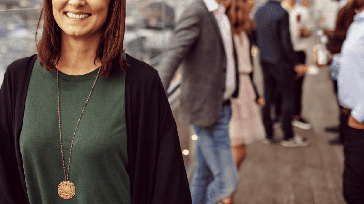 Smiling woman at outdoor party with people
