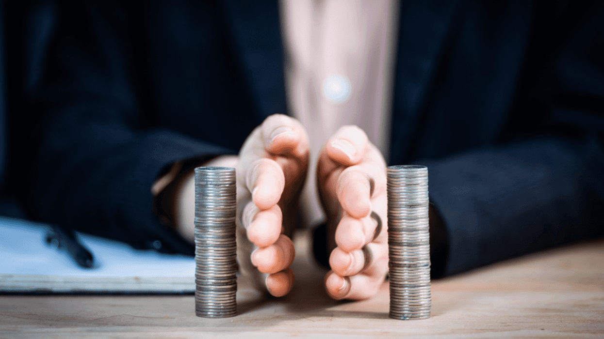 Someone dividing two piles of coins.