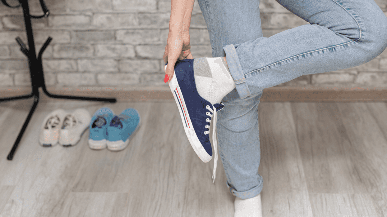 Someone taking off their sneakers.