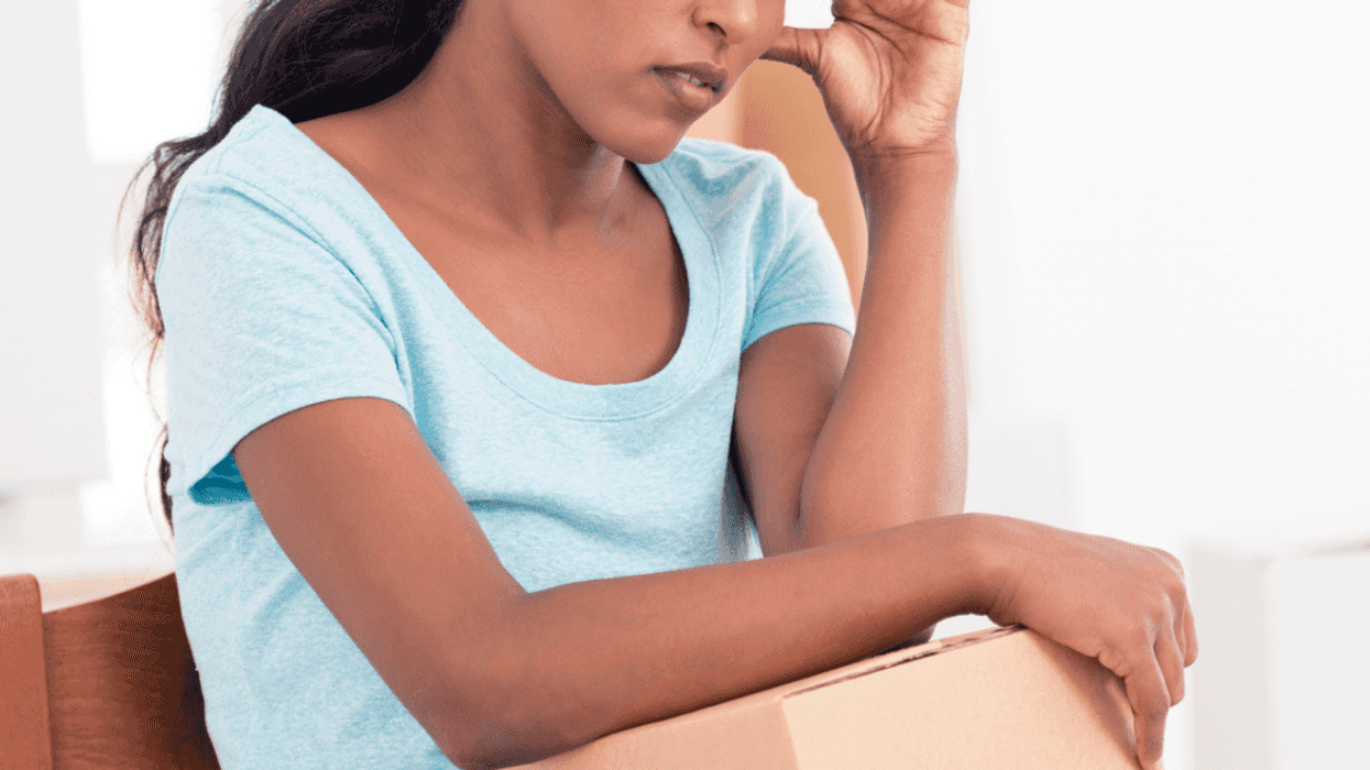 Stressed mom with moving boxes