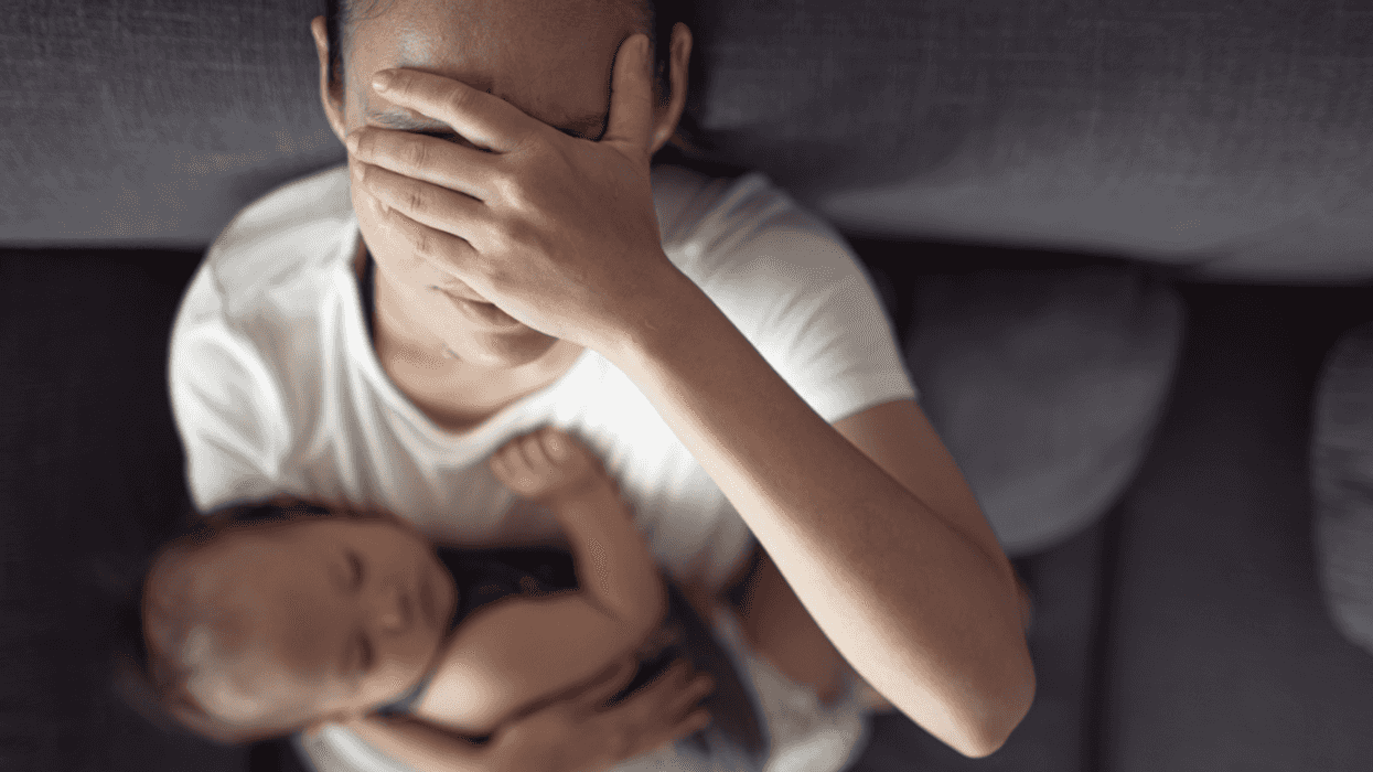 Stressed out mom holding her baby