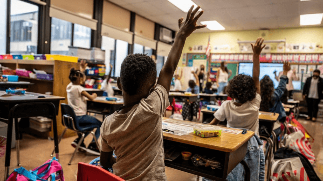 Student raising his hand in class