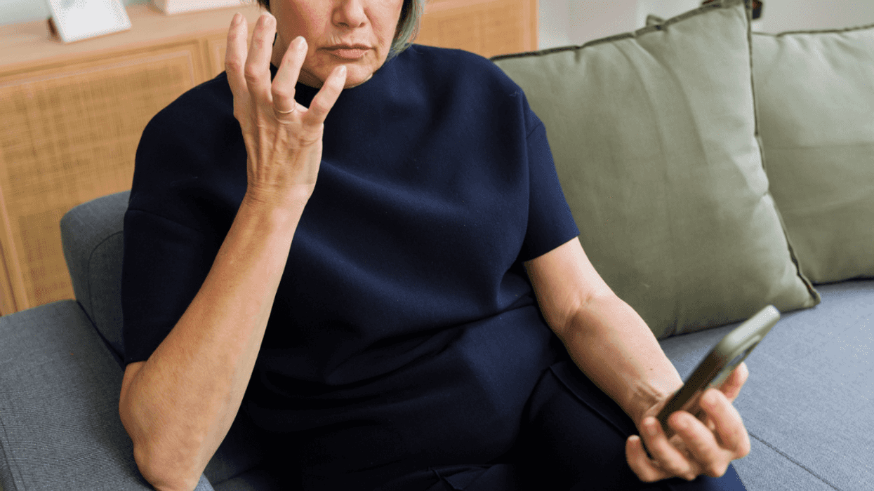 Stunned older woman looking at her phone