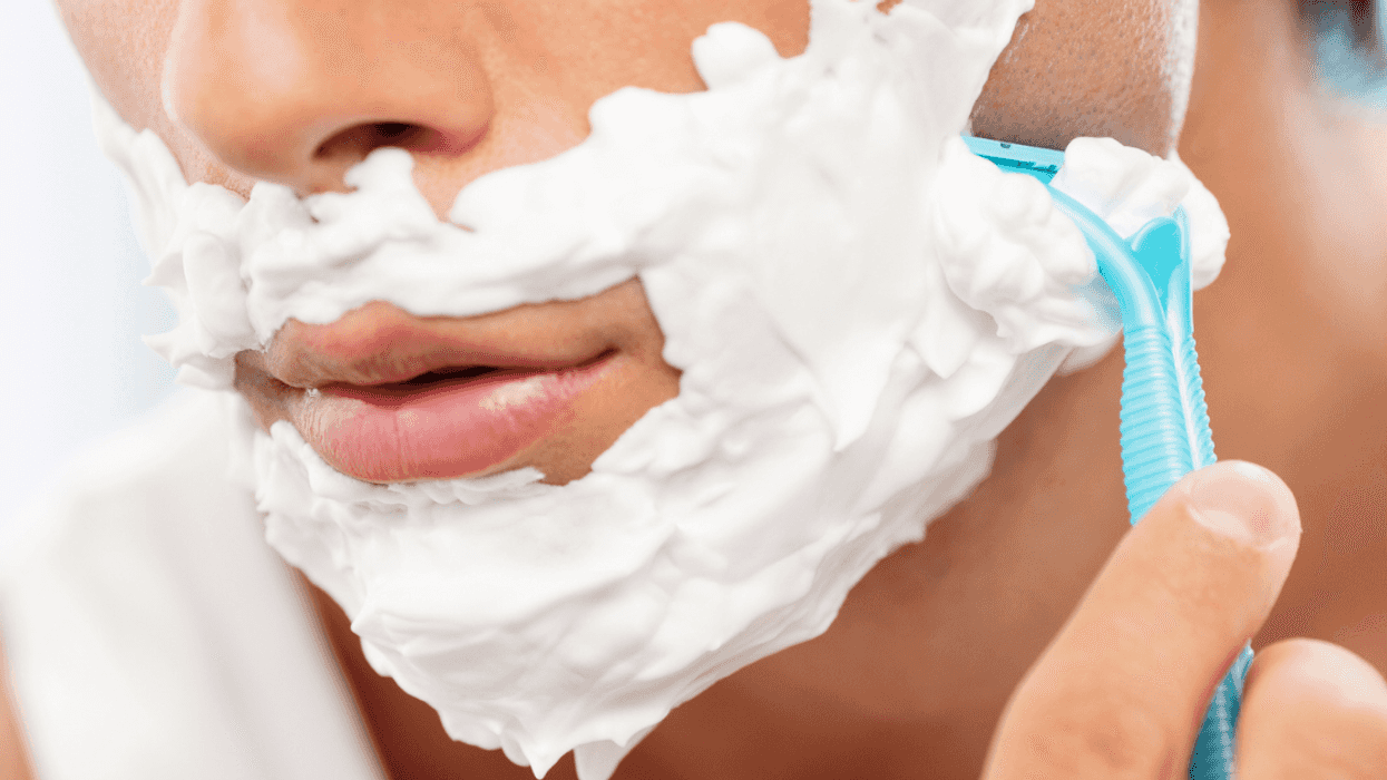 Teen boy shaving facial hair