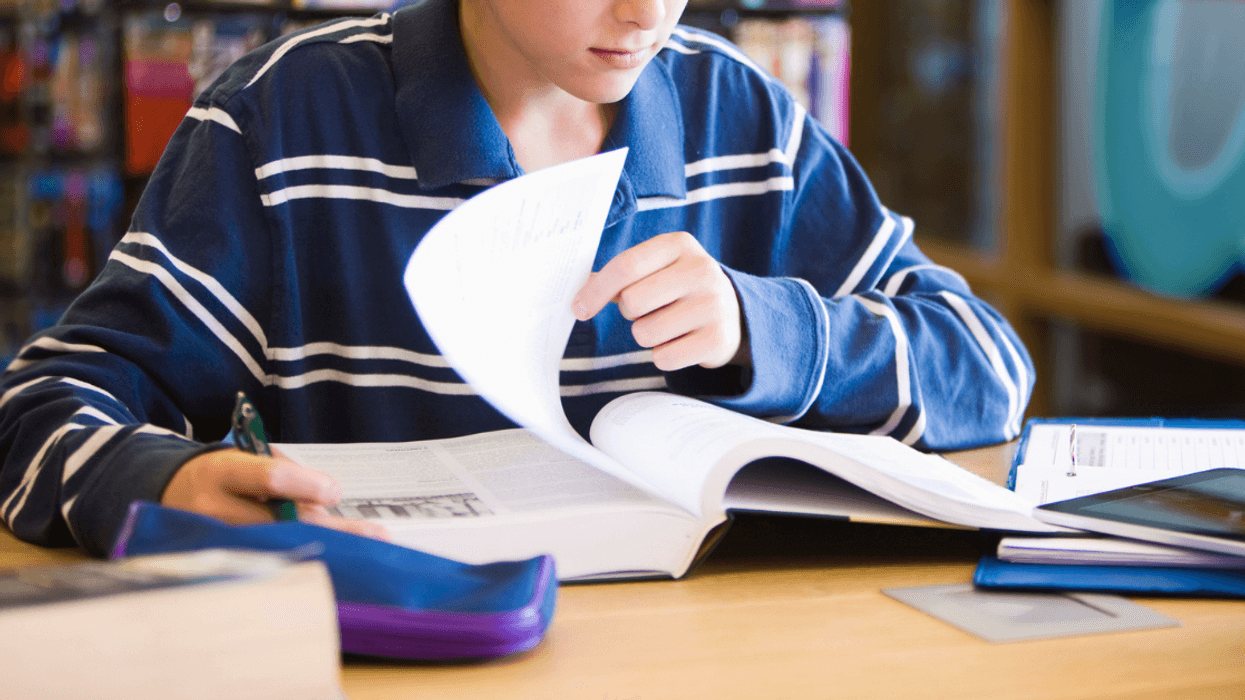 Teen boy working on project at school