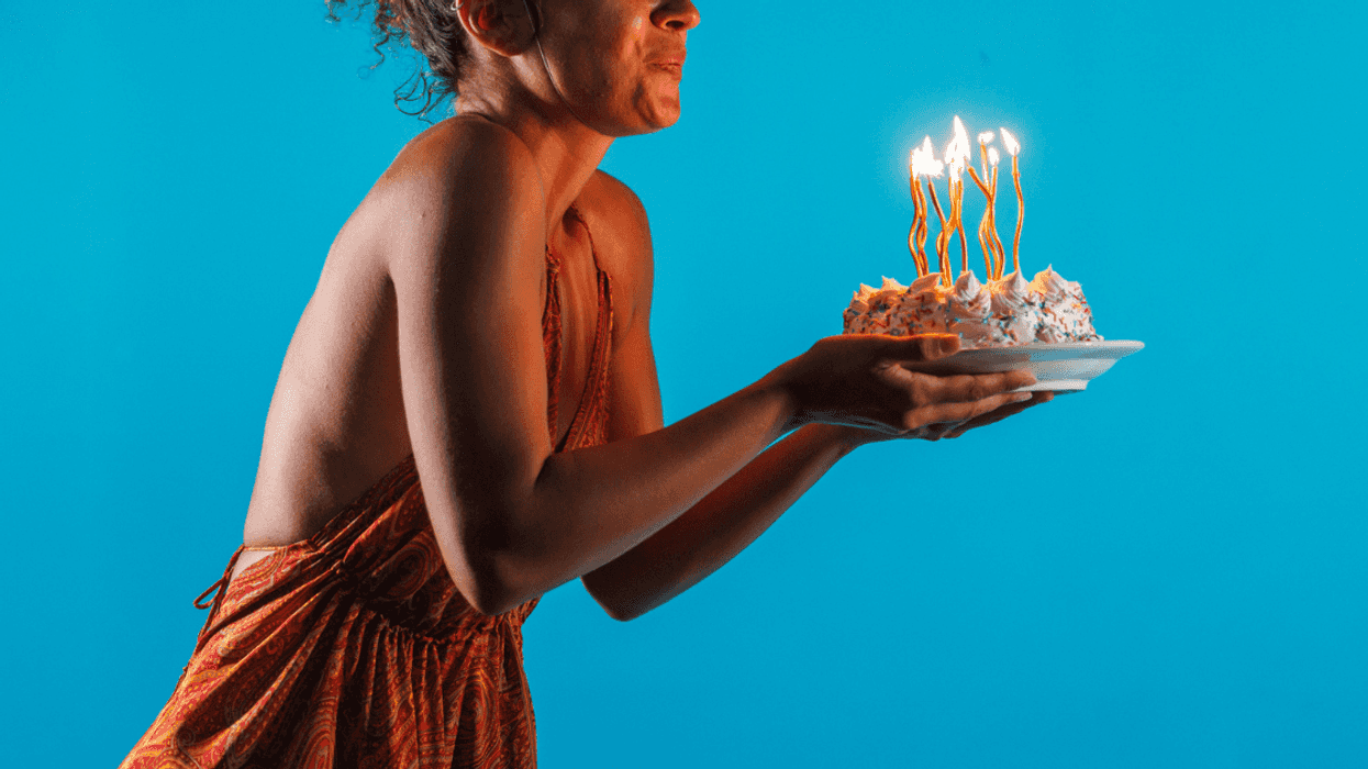Teen girl blowing out birthday candles