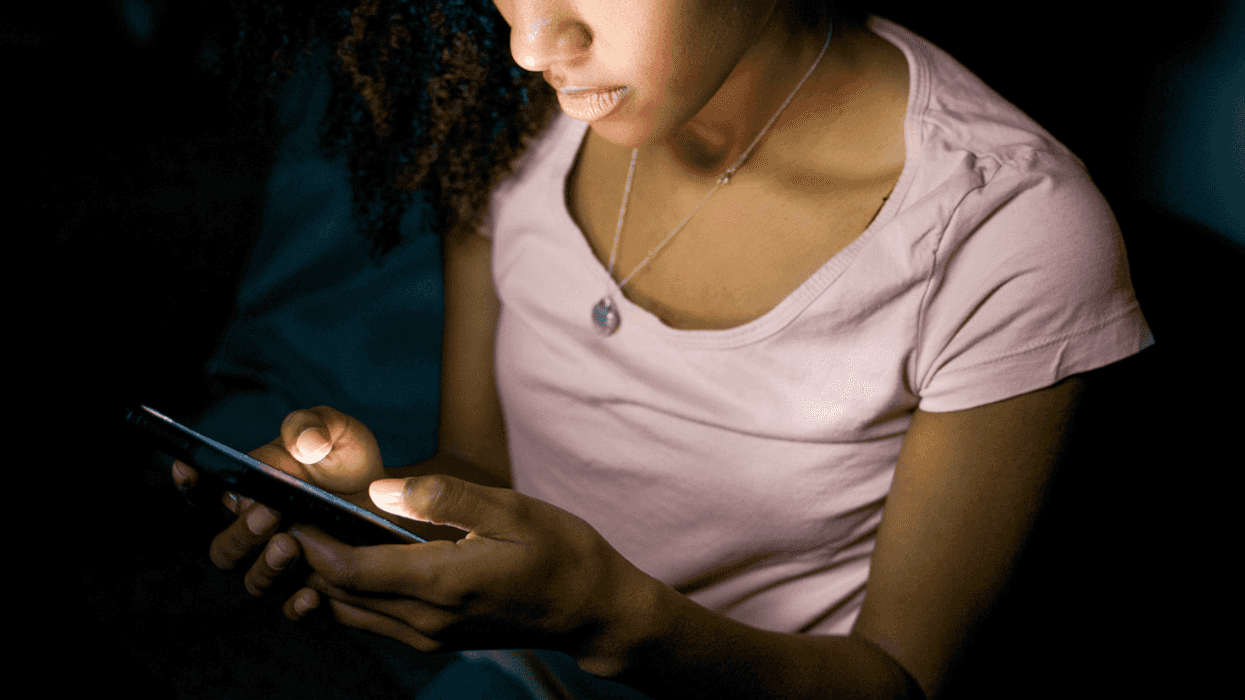 Teen girl dialing phone