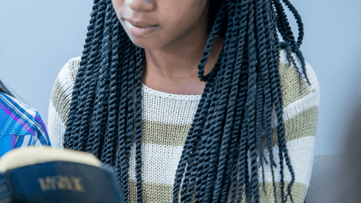 Teen girl reading the Bible at church
