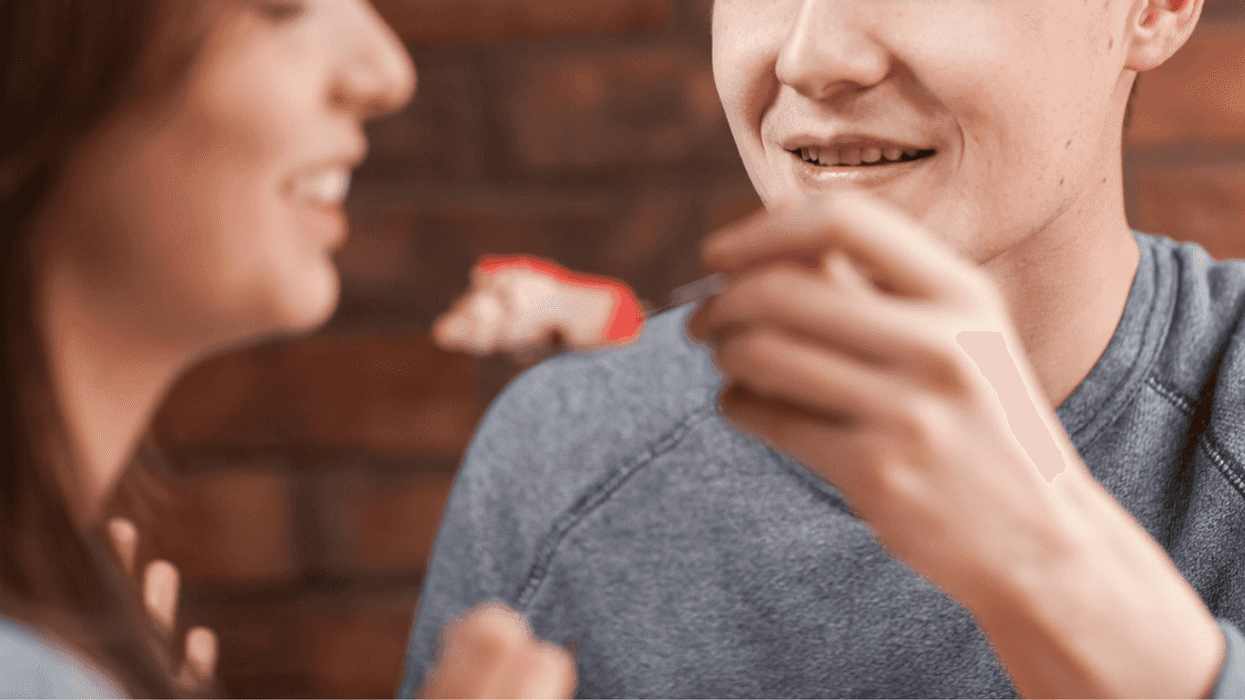 Teen guy spoon feeding teen girl