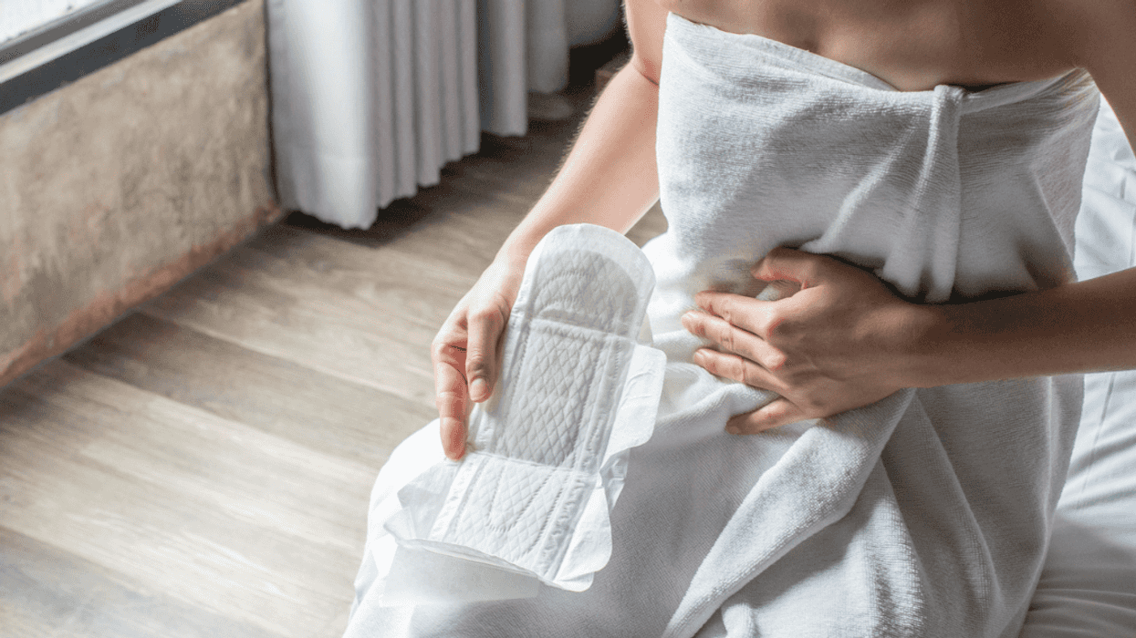 Teen with feminine products in bathroom