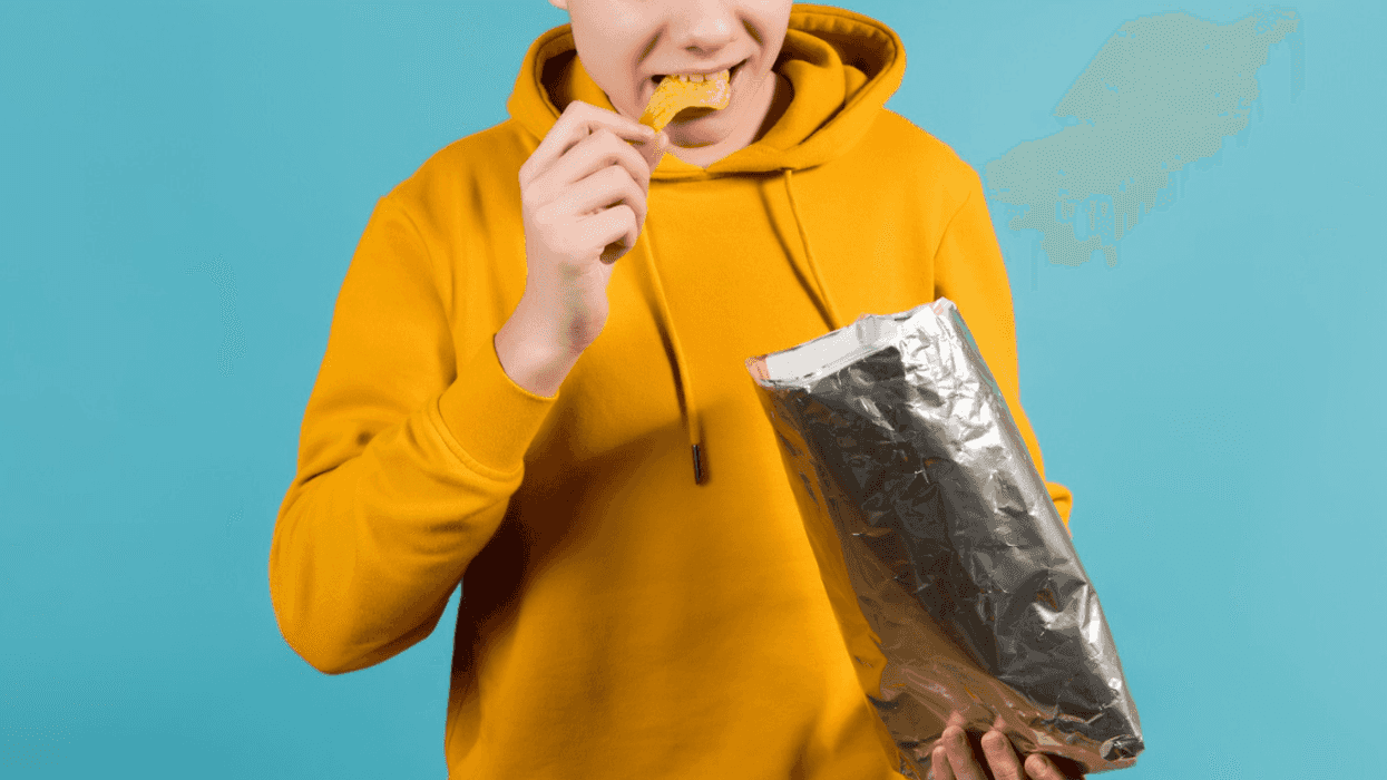 teenage boy eating nacho tortilla chips