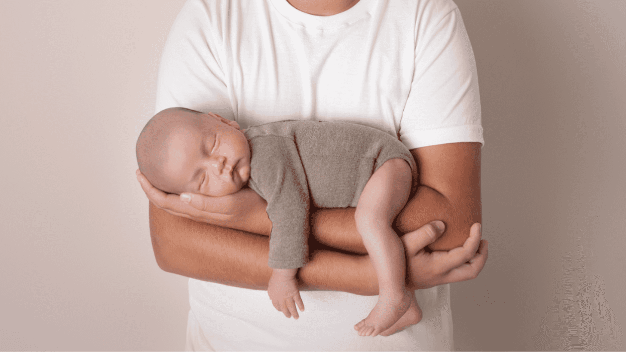 Teenage boy holding a baby