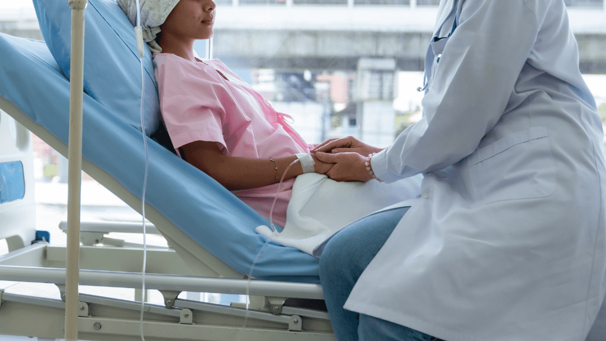 teenage girl in hospital bed with doctor