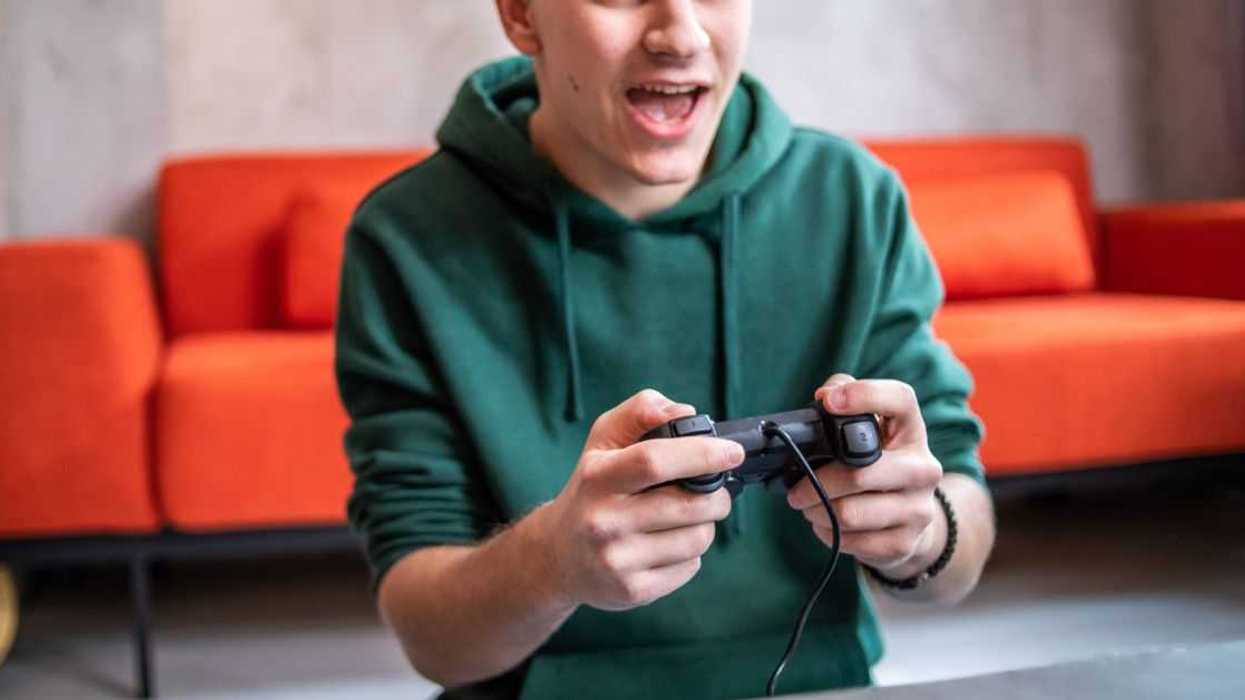 Teenager playing video game