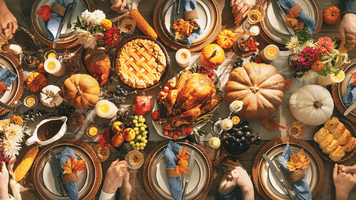 Thanksgiving meal with people holding hands around table