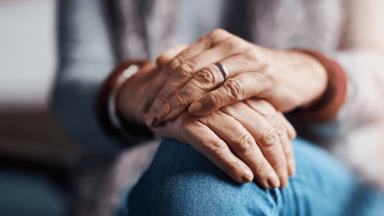 The hands of an older woman resting on our knees.
