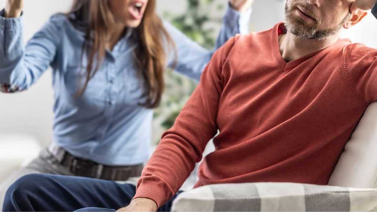 The wife is shouting at her partner who is ignoring her.