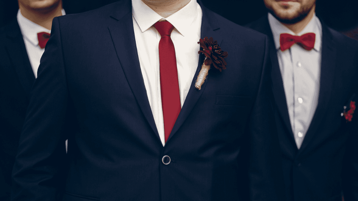 three men in matching blue suits with red boutonnieres and ties