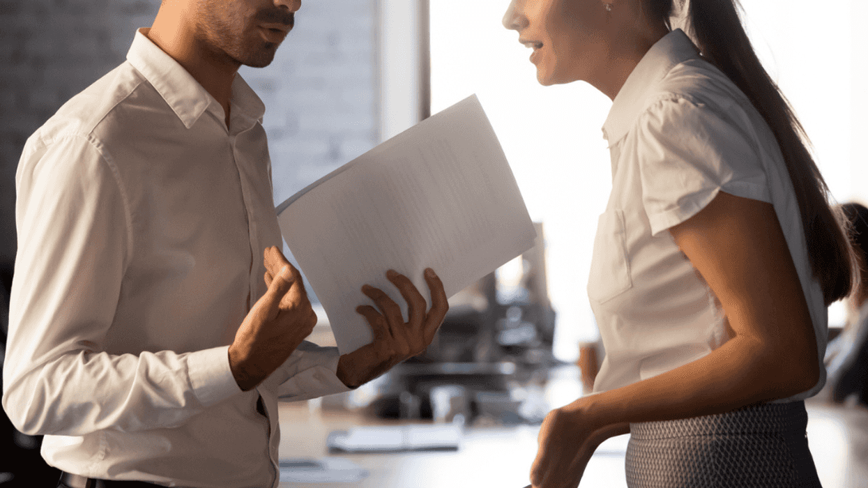 Two coworkers arguing in office