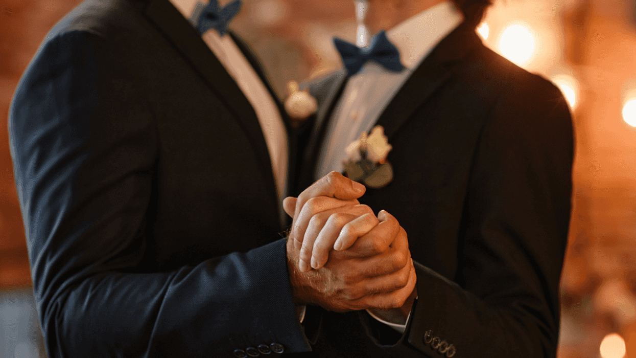 Two men in tuxedos dancing.