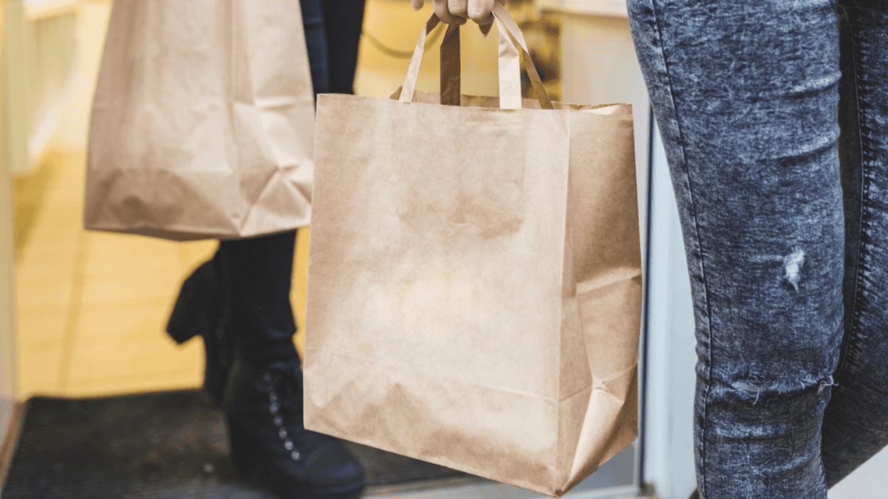 Two people carrying groceries