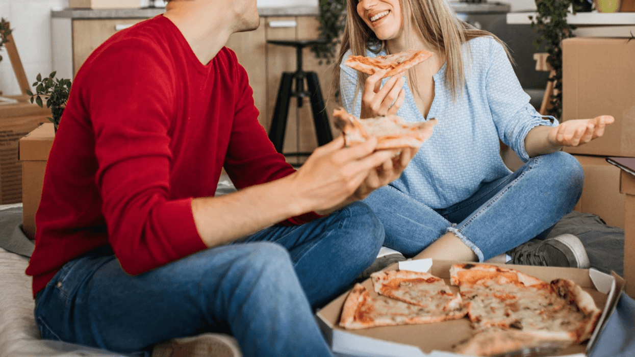 two people eating delivery pizza together