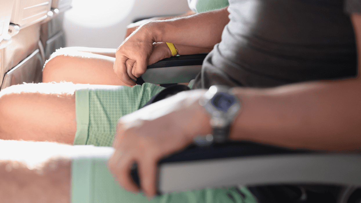 Two people on airline seats.