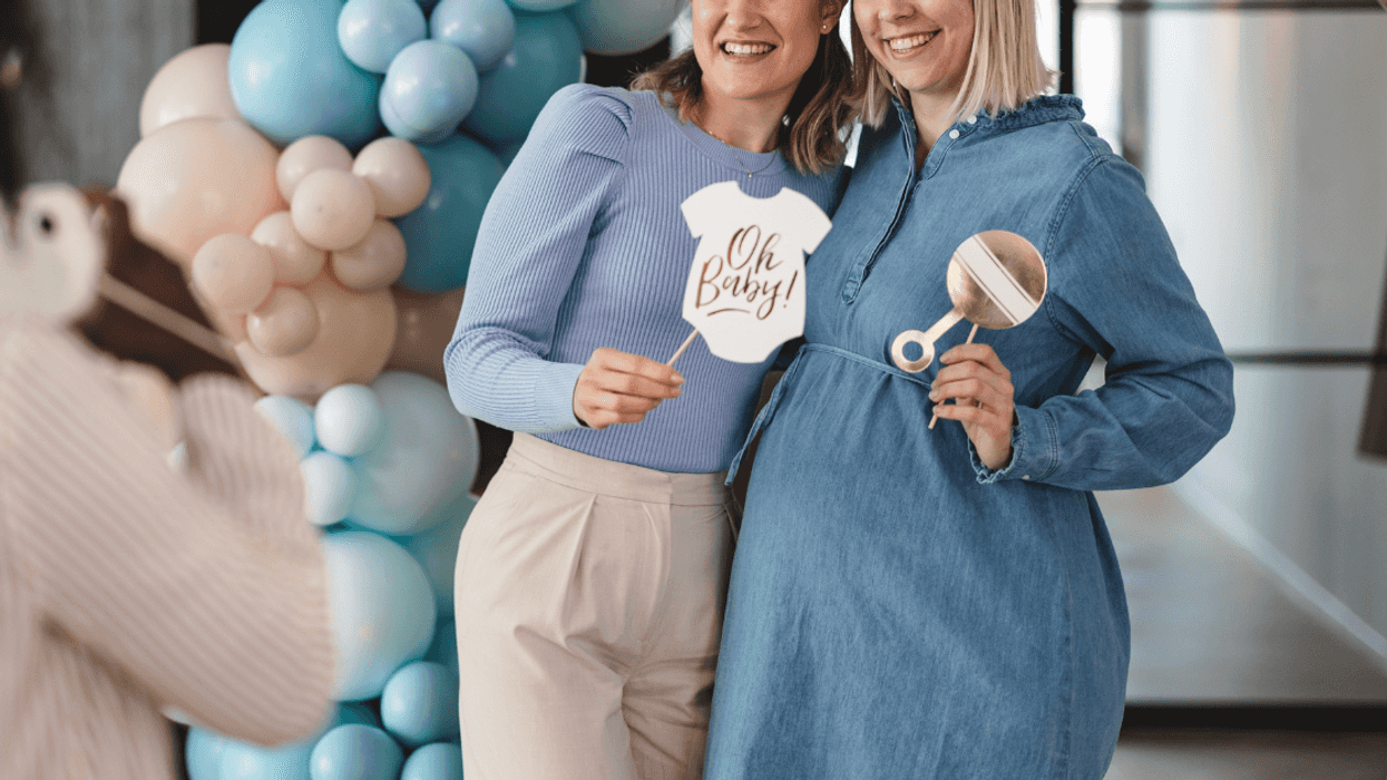 two people pose for photo at baby shower